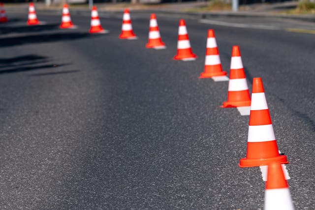 Police have launched an investigation after a video showing a driver moving traffic cones to escape congestion went viral (Alamy/PA)