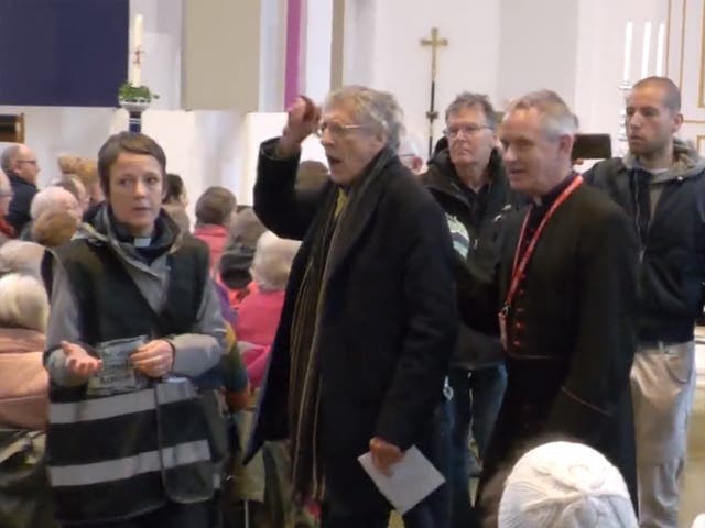 <p>Corybn (second from left) was led out of the church ranting </p>
