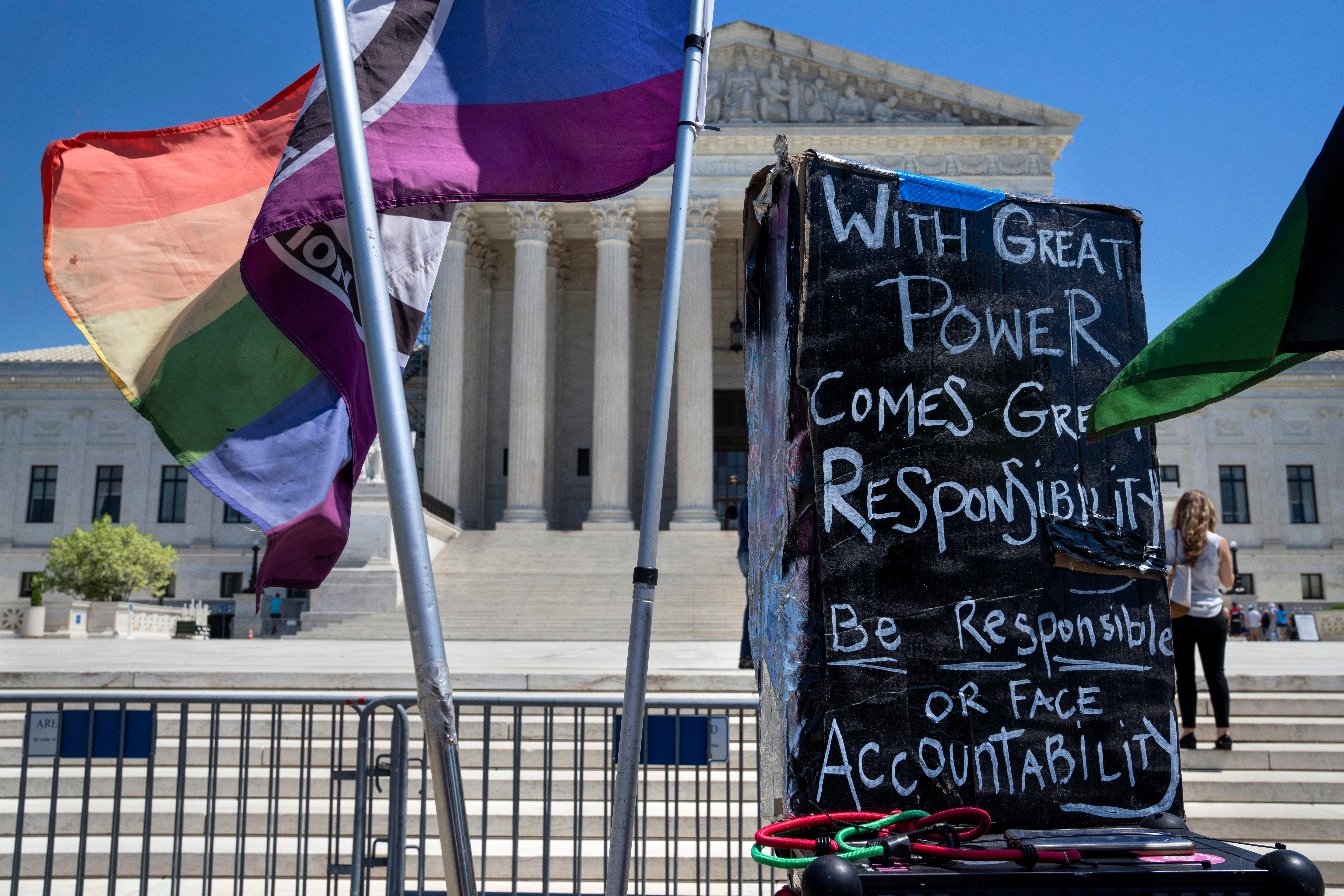 Flags and signs join protests outside the Supreme Court on Friday as Americans await a decision in an abortion drug case with national implications.