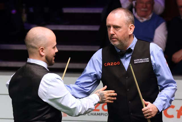 Luca Brecel (left) reached the World Snooker Championship quarter-finals by beating Mark Williams (Nigel French/PA)