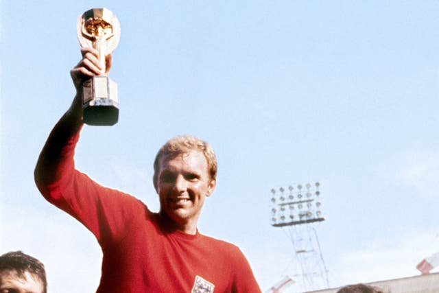 Bobby Moore celebrates winning the 1966 World Cup at Wembley (PA)