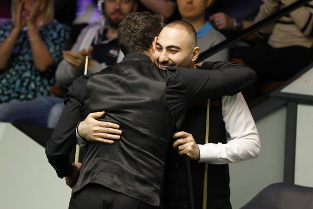 <p>Ronnie O’Sullivan and Hossein vafaei hugged at the end of their second-round contest </p>