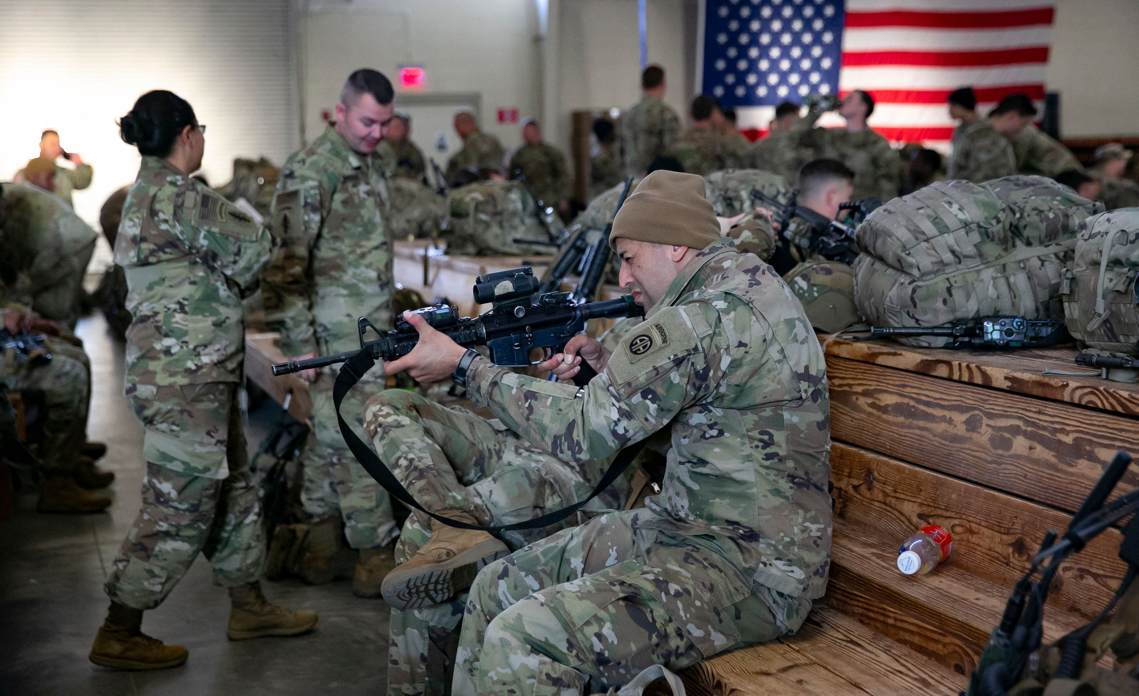 A soldier of the 82nd Airborne Division checks his weapon before deploying to Europe