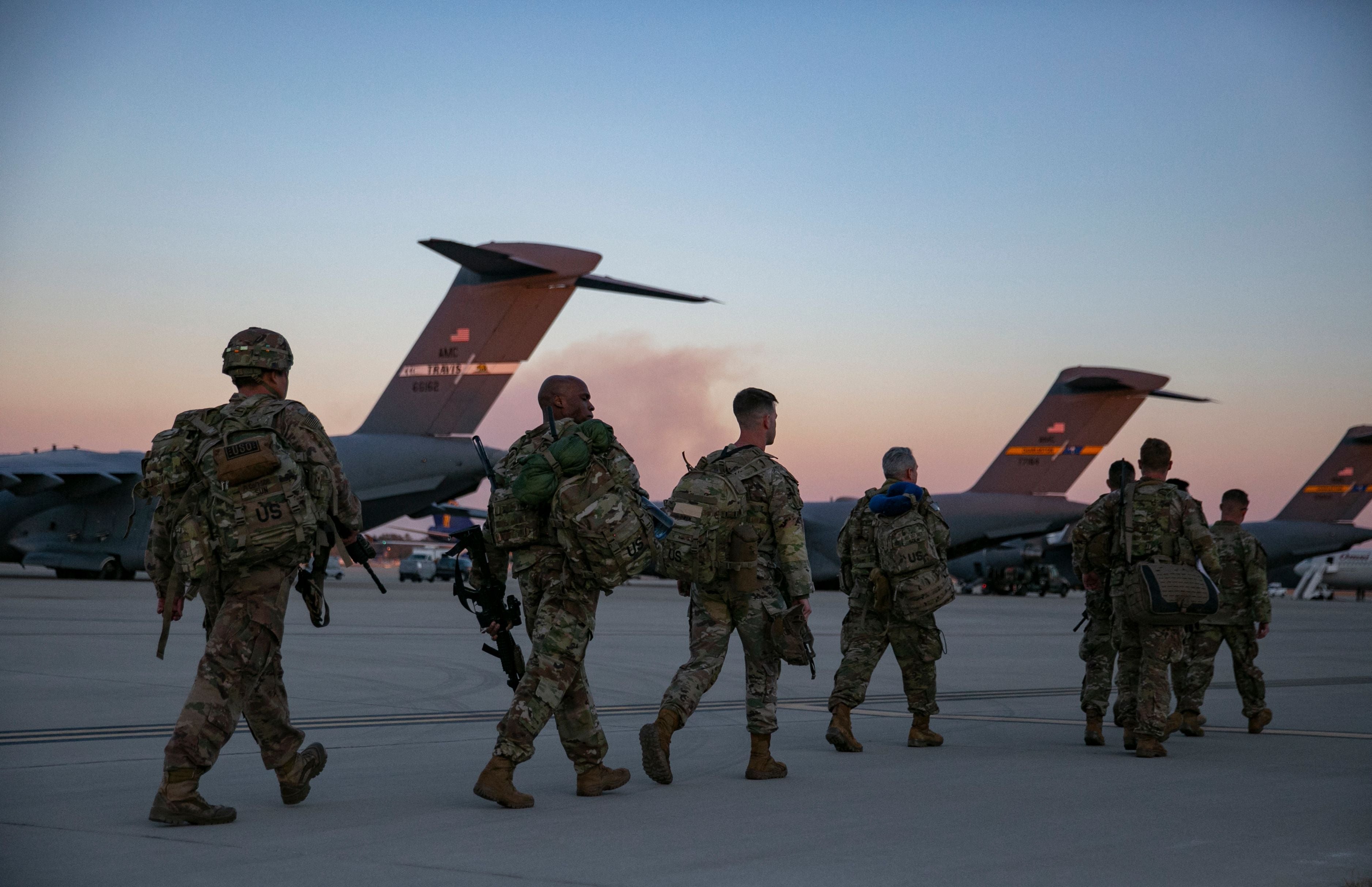 Soldiers of the 82nd Airborne Division board a plane from Pope Army Airfield in Fort Bragg heading to Europe