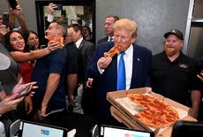 Trump offers fans a slice of pizza - after taking a massive bite out of it