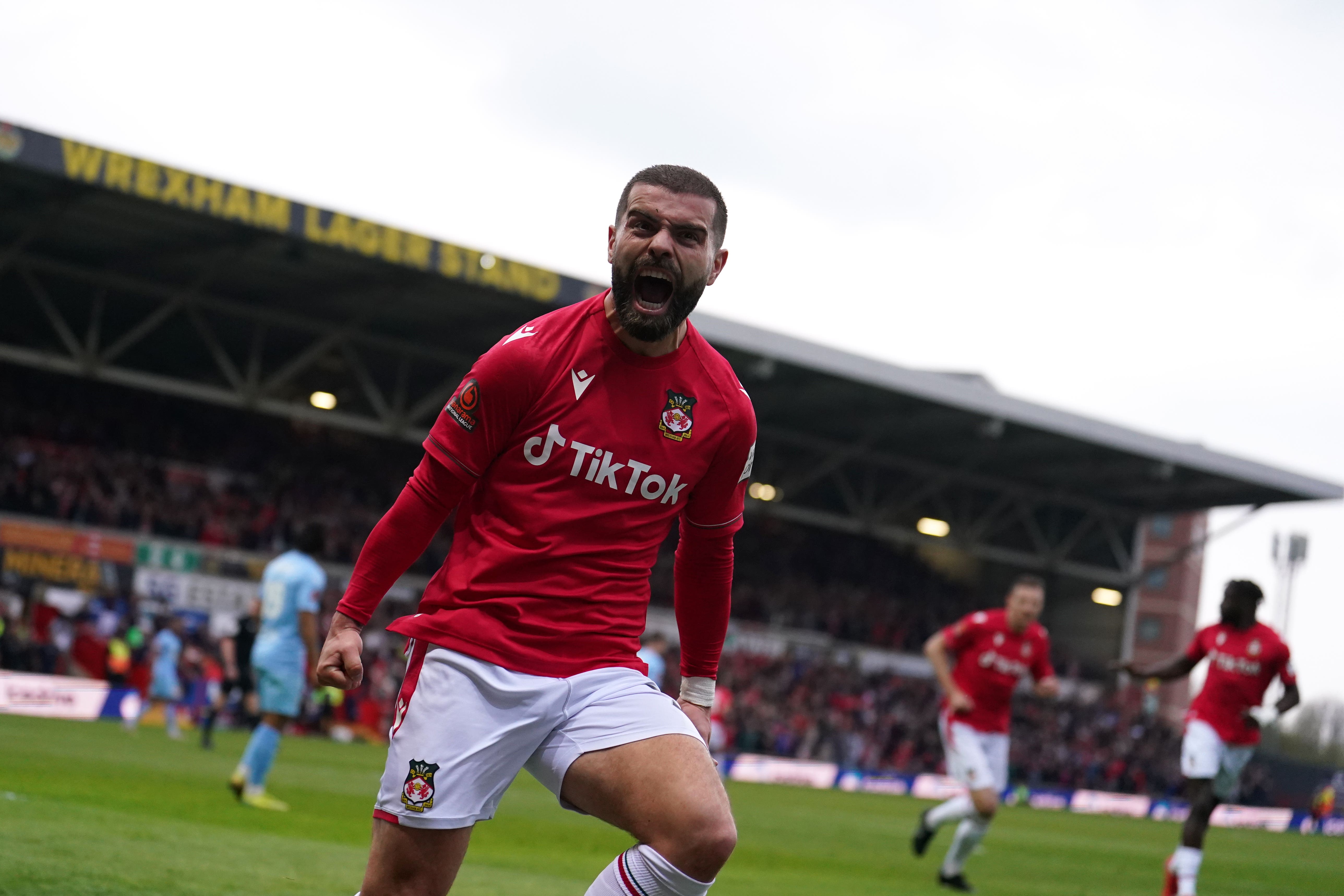 Wrexham’s Elliot Lee celebrates opening the scoring (PA)