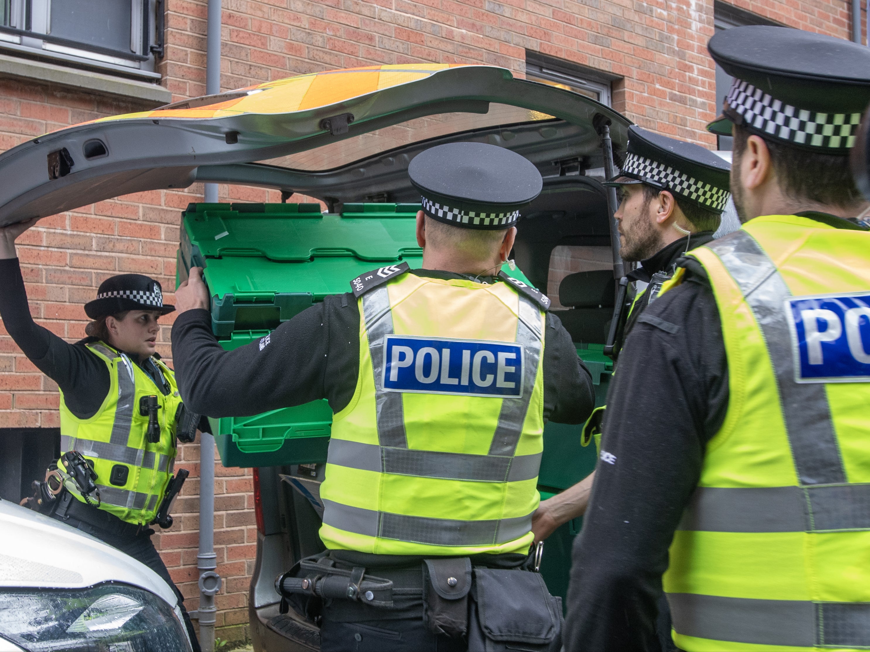 Officers from Police Scotland leave the SNP headquarters with evidence earlier this month