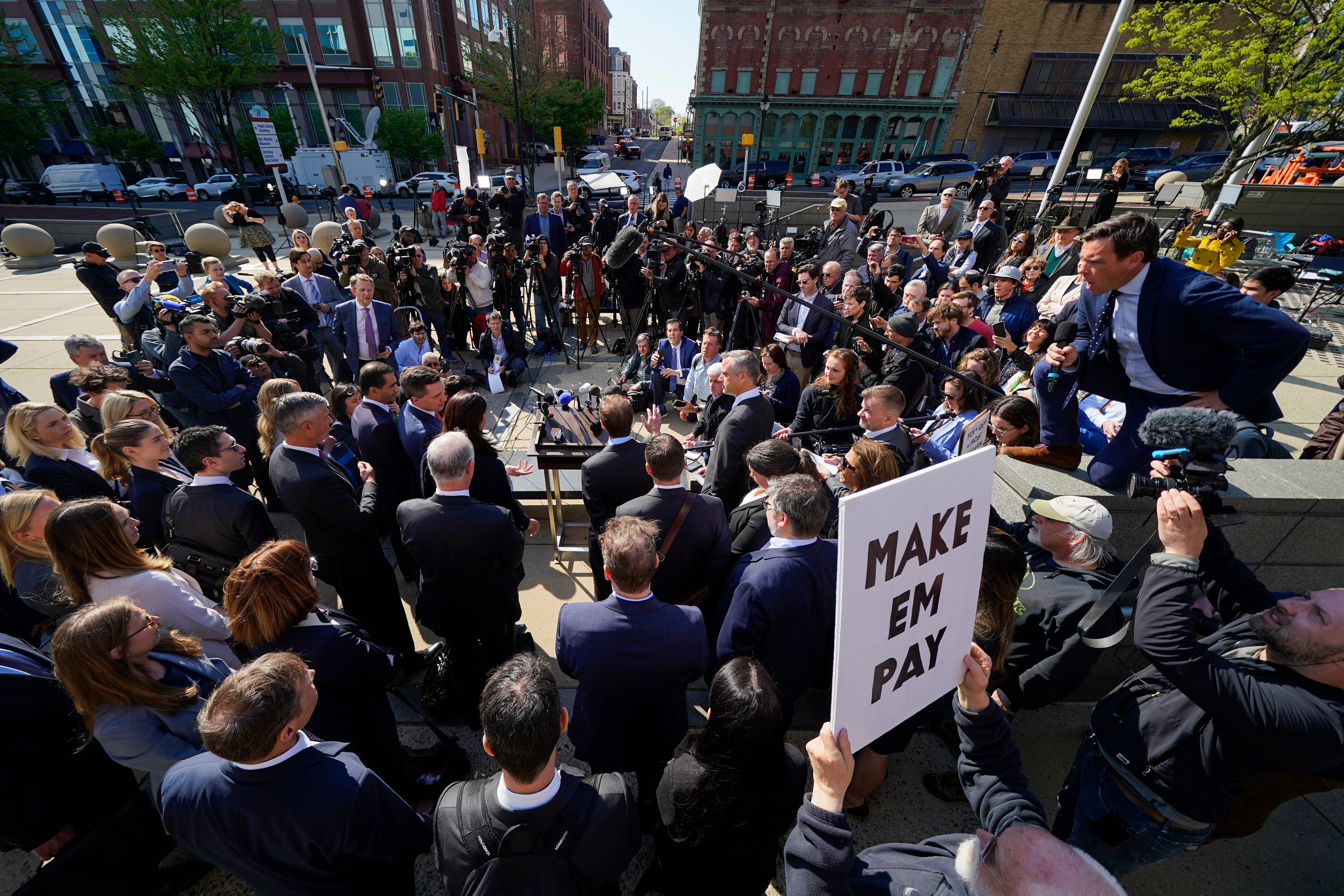 Reporters surround attorneys for Dominion Voting Systems during a news conference outside the New Castle County Courthouse in Wilmington, Delaware, after the defamation lawsuit against Fox News was settled on Tuesday, April 18, 2023
