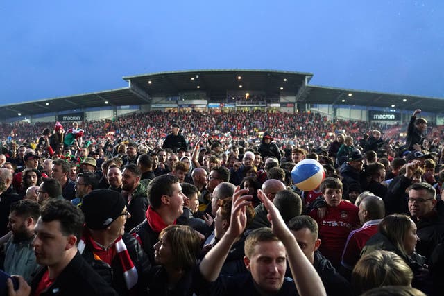 Wrexham fans celebrate winning the National League on Saturday and are now dreaming of progressing through the English Football League (Martin Rickett/PA)