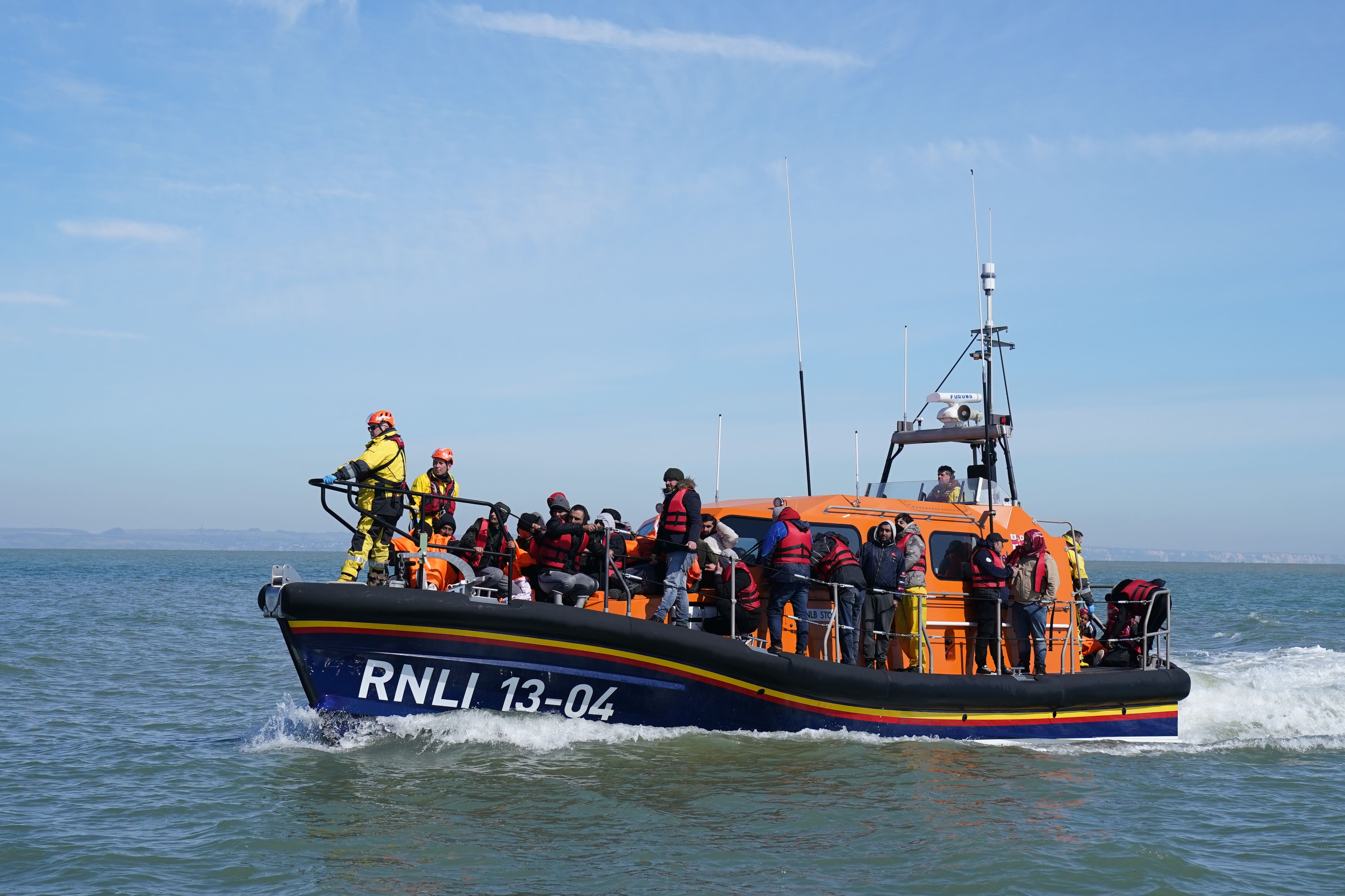 A group of people thought to be migrants are brought in to Dungeness, Kent, by the RNLI, following a small boat incident in the Channel (Gareth Fuller/PA)
