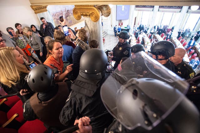 <p>Law enforcement forcibly clear the Montana House of Representatives gallery during a protest after the Speaker of the House refused again to acknowledge Rep. Zooey Zephyr, D-Missoula, on Monday, April 24, 2023, in the State Capitol, in Helena, Montana</p>