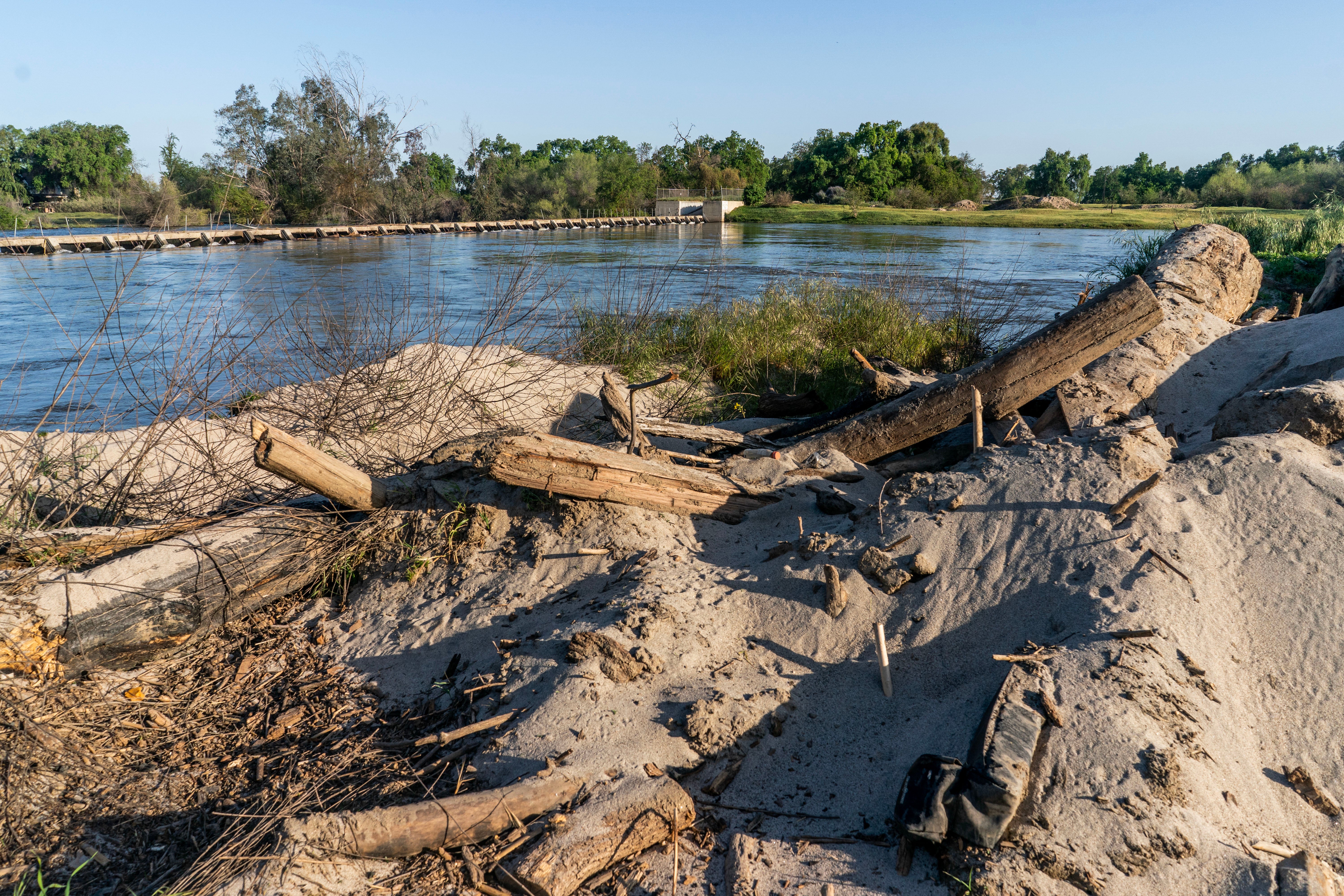 Sand and debris on the banks of Kings River in San Joaquin Valley after the storms