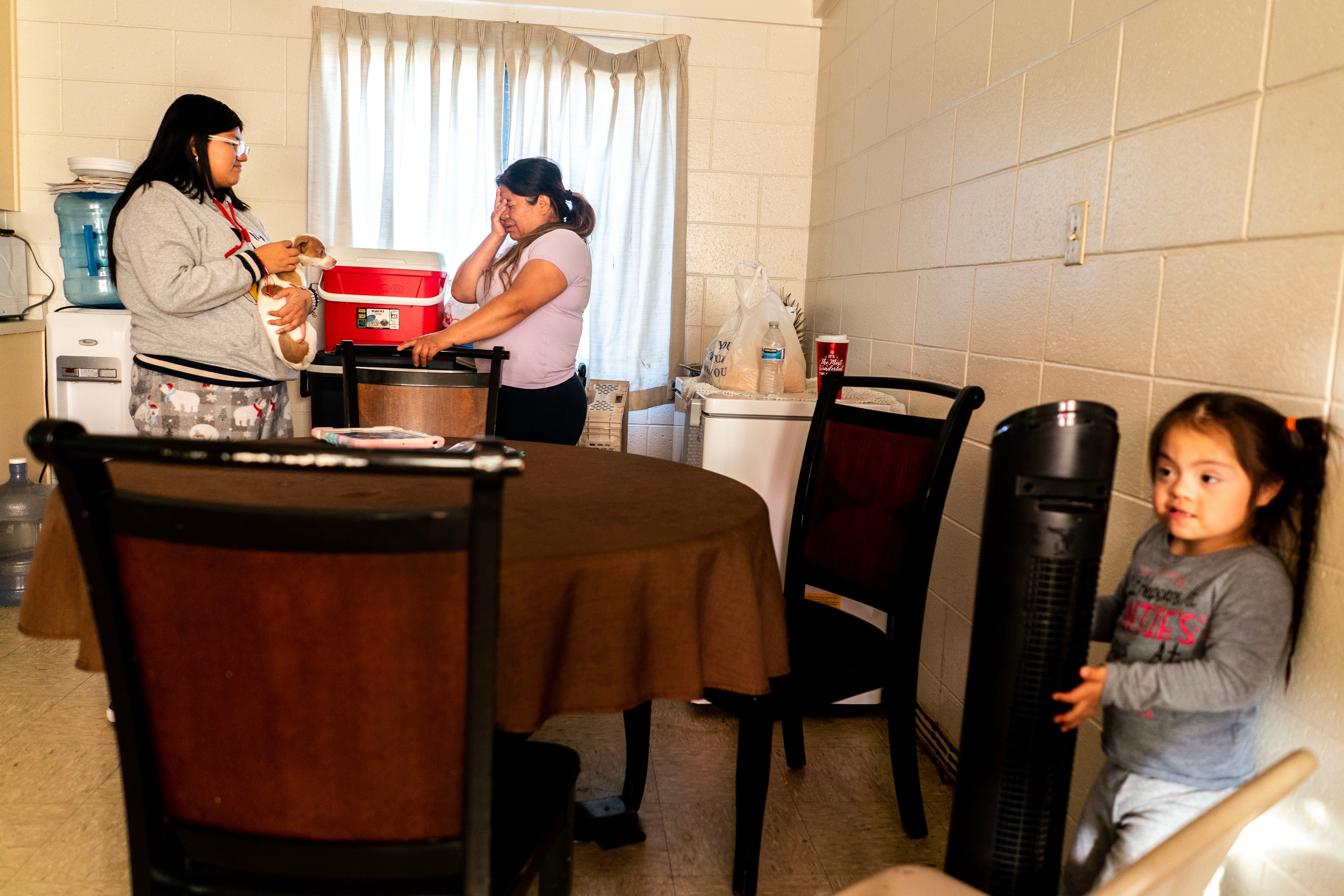 Maria Perez at home with her daughters Maria, 16, and Leslie, five. Perez had to throw out her living room furniture after the family’s home flooded