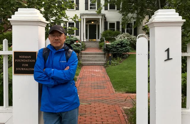 <p>Dong Yuyu stands at the gates of the Nieman Foundation for Journalism at Harvard University in Cambridge</p>