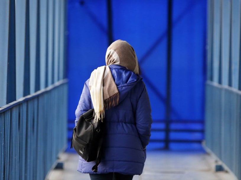 An Iranian woman walks on a pedestrian bridge in Tehran, Iran, 10 January 2023