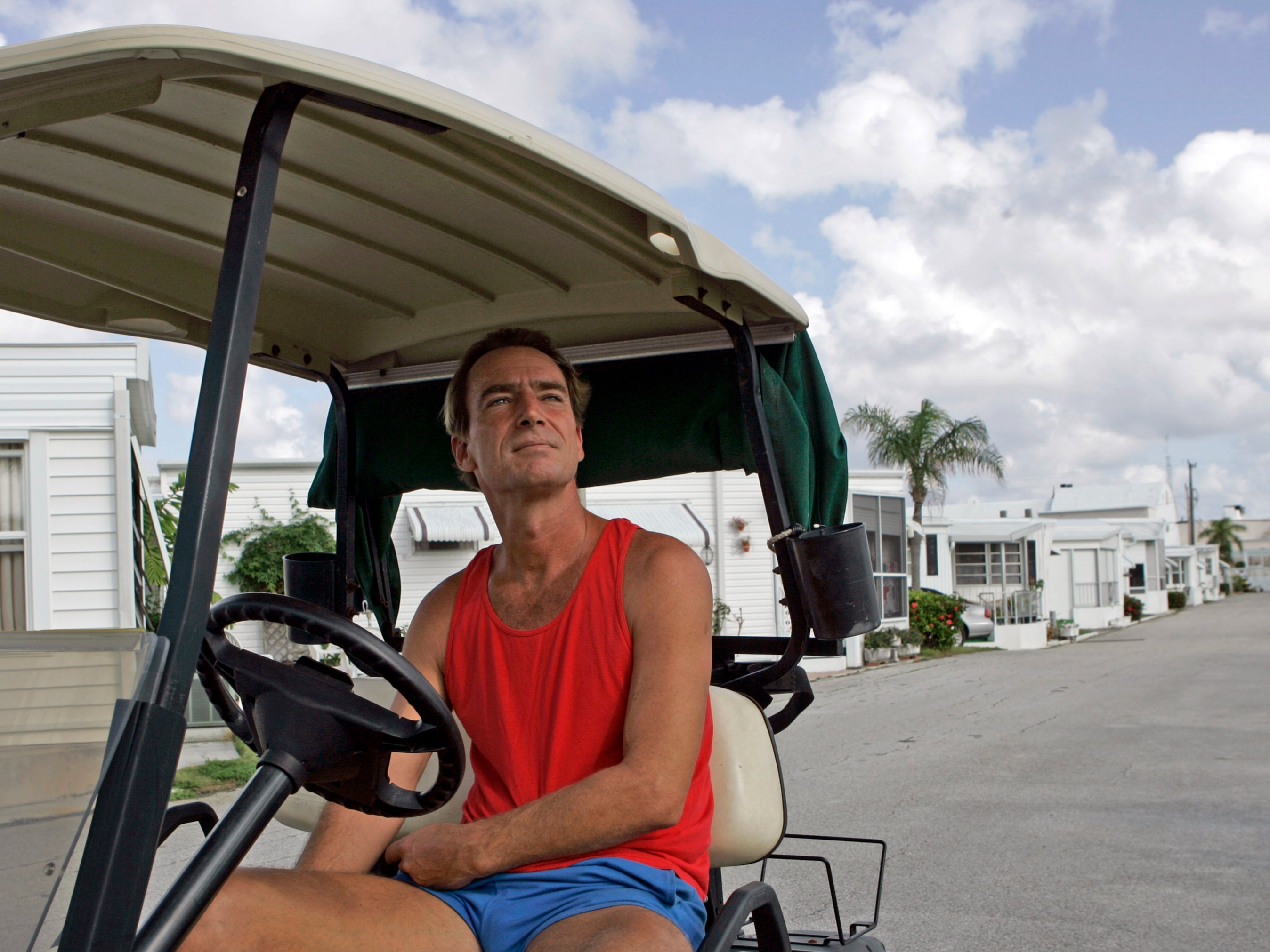 Kevin Dwyer sits in his golf cart at the Briny Breezes trailer park in Briny Breezes, Fla., Monday, Dec. 18, 2006. If residents approved the sale of the community to a developer for more than a half billion dollars, nearly each trailer owner would have become an instant millionaire. "I've nickeled and dimed my whole life. I hit the lottery." Dwyer, who paid just $37,500 for his trailer nine years ago, would make about $800,000. (AP Photo/Alan Diaz)