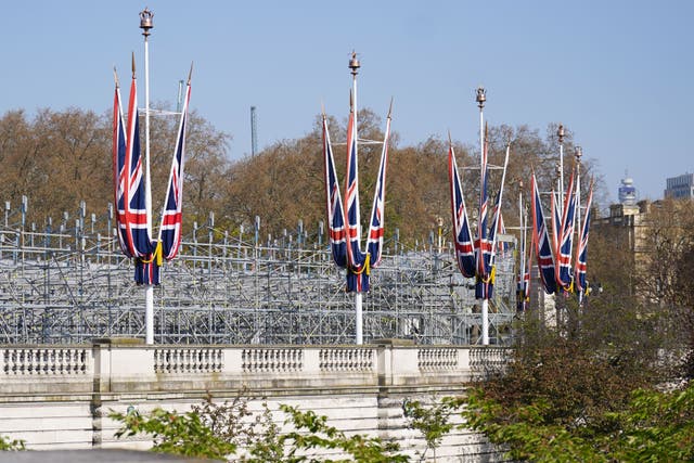 Union flags hang from the street furniture as seating is set up outside Buckingham Palace (James Manning/PA)