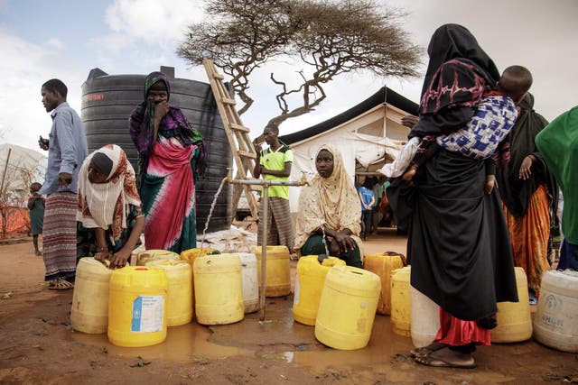 <p>Somali refugees put water containers for the water distribution by French charity Doctors Without Borders (MSF) in the Dadaab refugee camp, one of Africa’s largest refugee camps in Kenya </p>