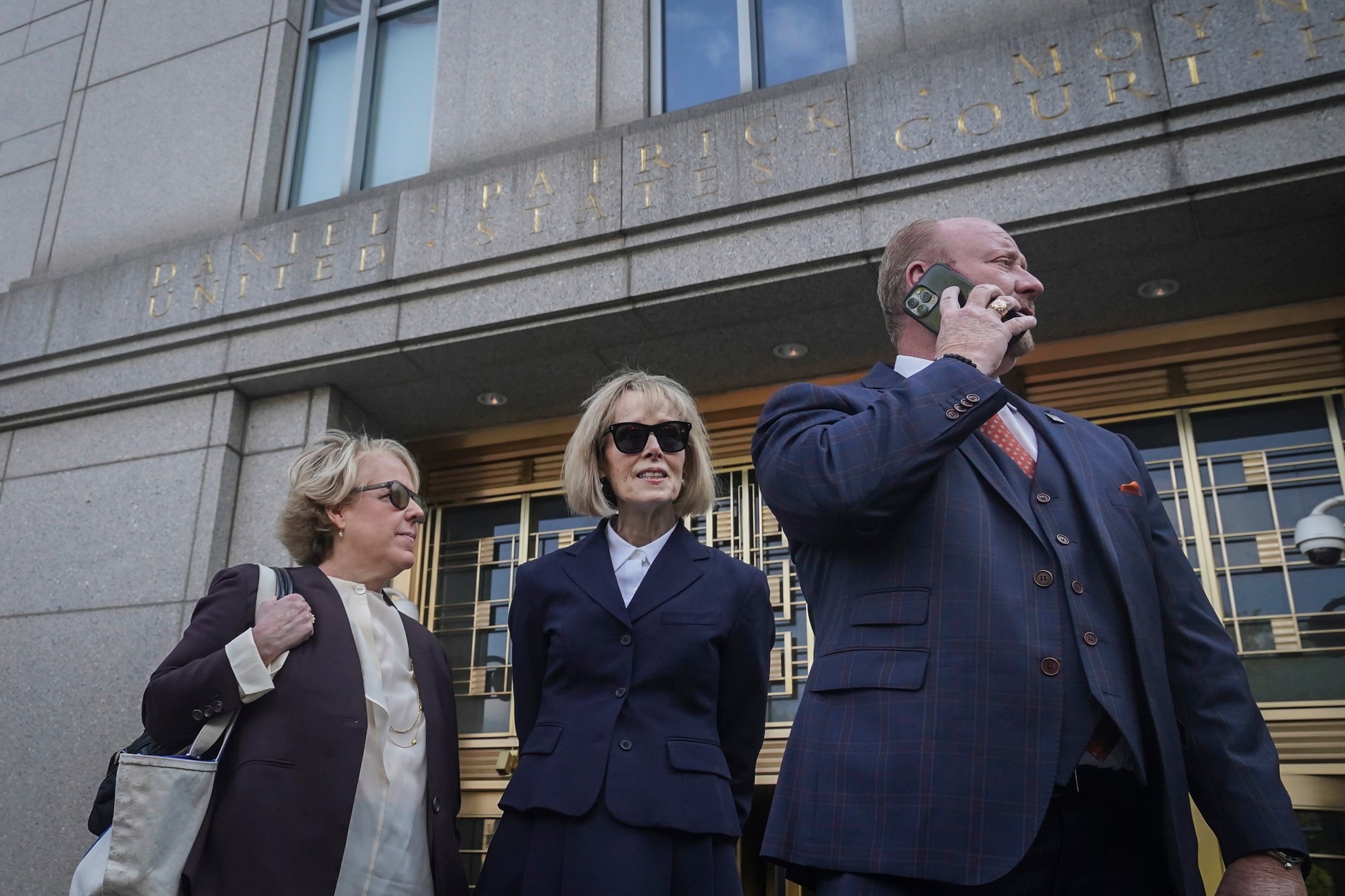 Former advice columnist E. Jean Carroll, center, leaves federal court with members of her legal team, after testifying in her rape trial against former President Donald Trump, Wednesday April 26, 2023, in New York