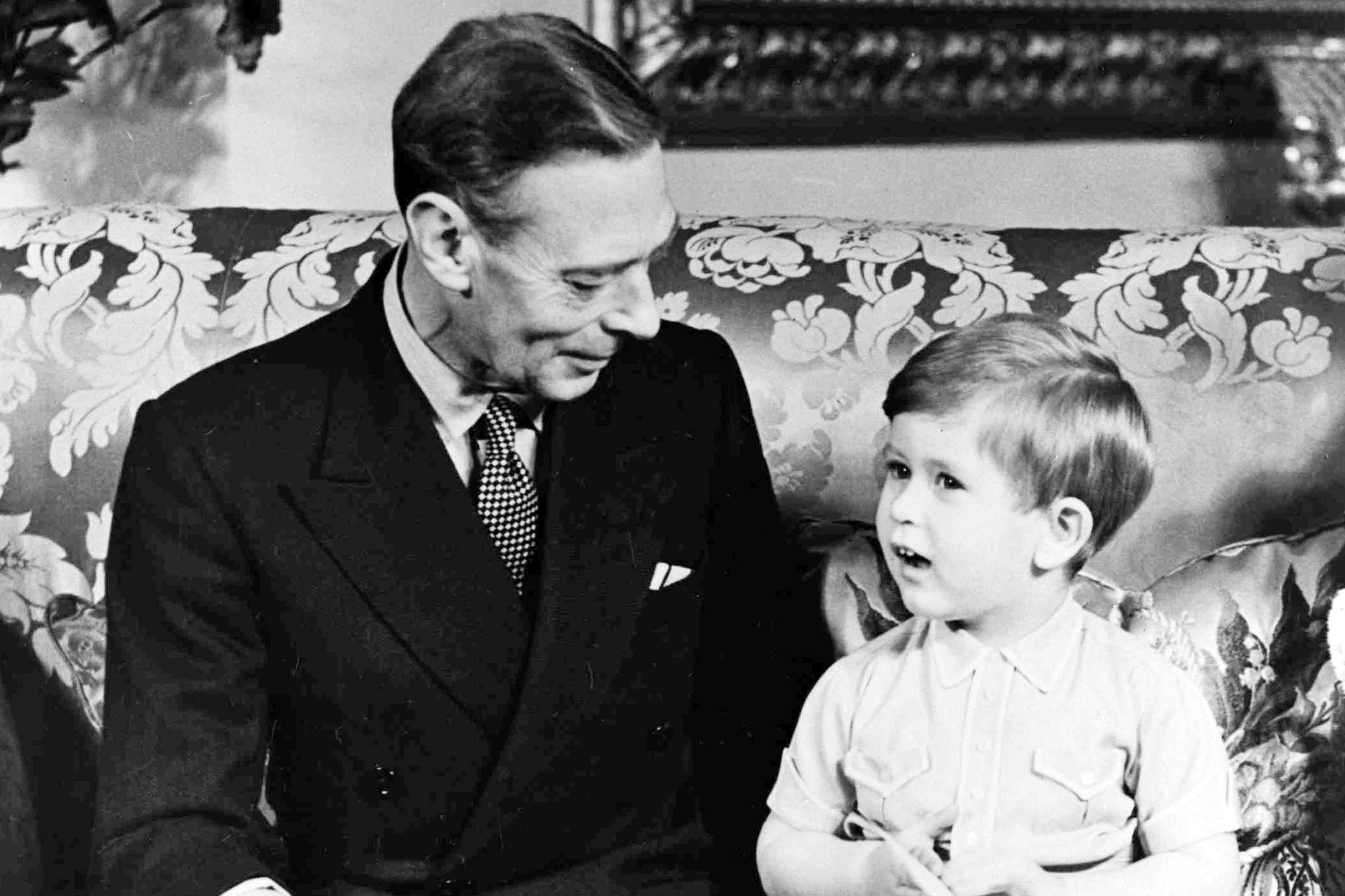 King George VI with his grandson Prince Charles celebrating his third birthday at Buckingham Palace, London