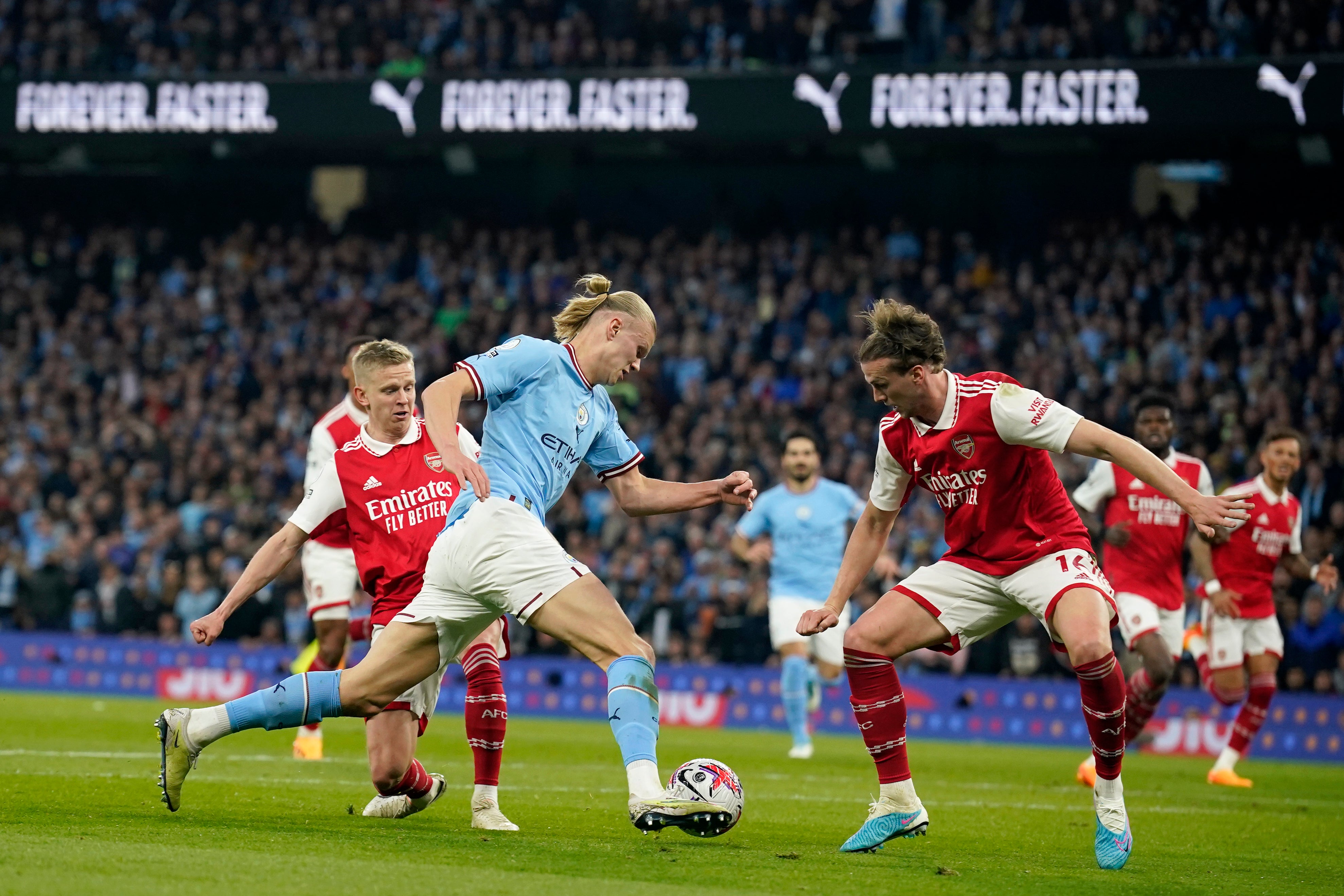 Erling Haaland takes on Rob Holding in the box
