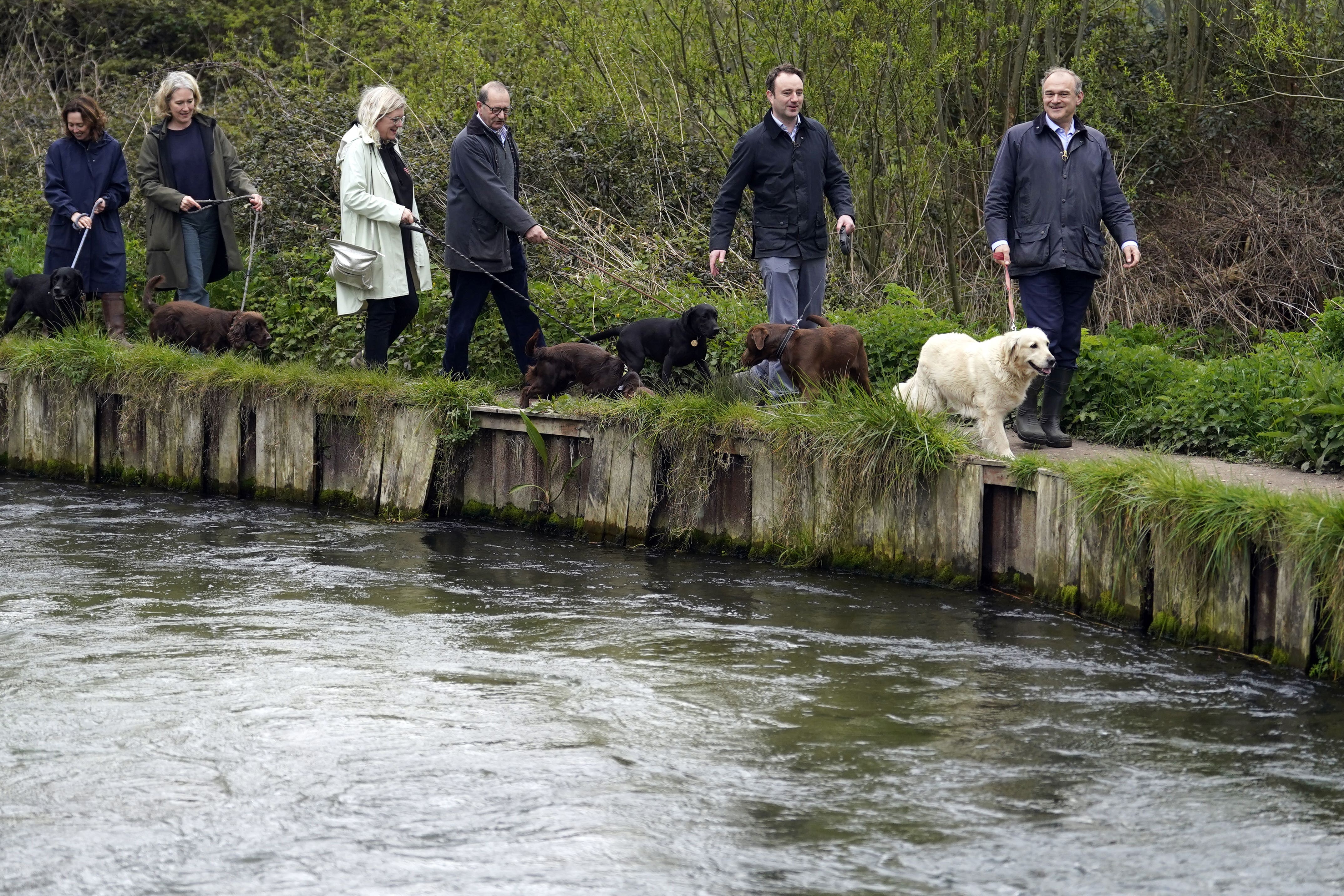 Liberal Democrat leader Sir Ed Davey (right) and Danny Chambers, the Liberal Democrats Parliamentary Candidate for Winchester & Chandler’s Ford (2nd right), during a local dog walk along the River Itchen near Winchester, a chalk stream which has been damaged by sewage discharges (Andrew Andrew Matthews/PA)