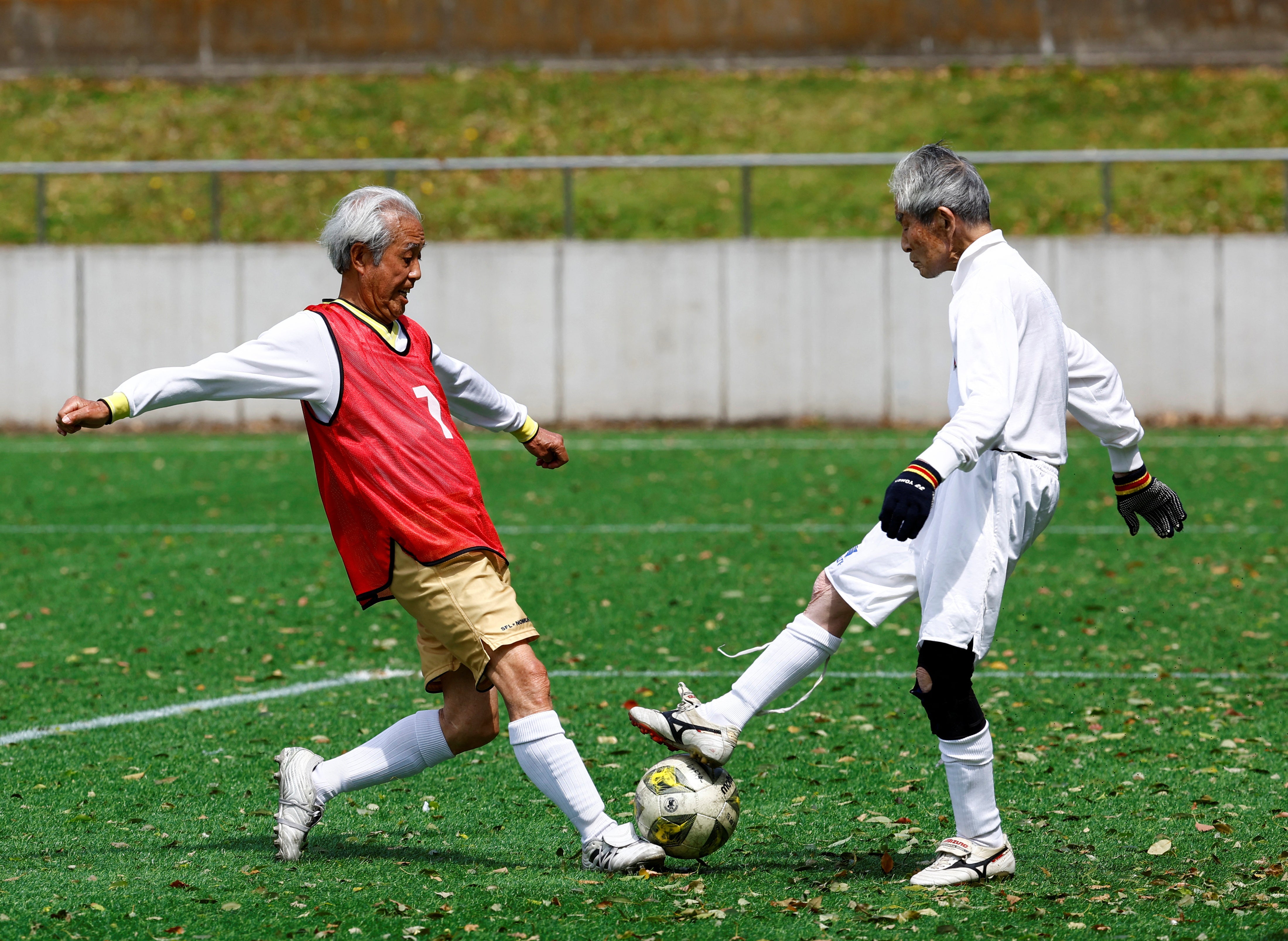Nomura shoots to score a goal against Blue Hawaii’s goalkeeper Hiroshi Nishino, 87, at the SFL 80 League opening match