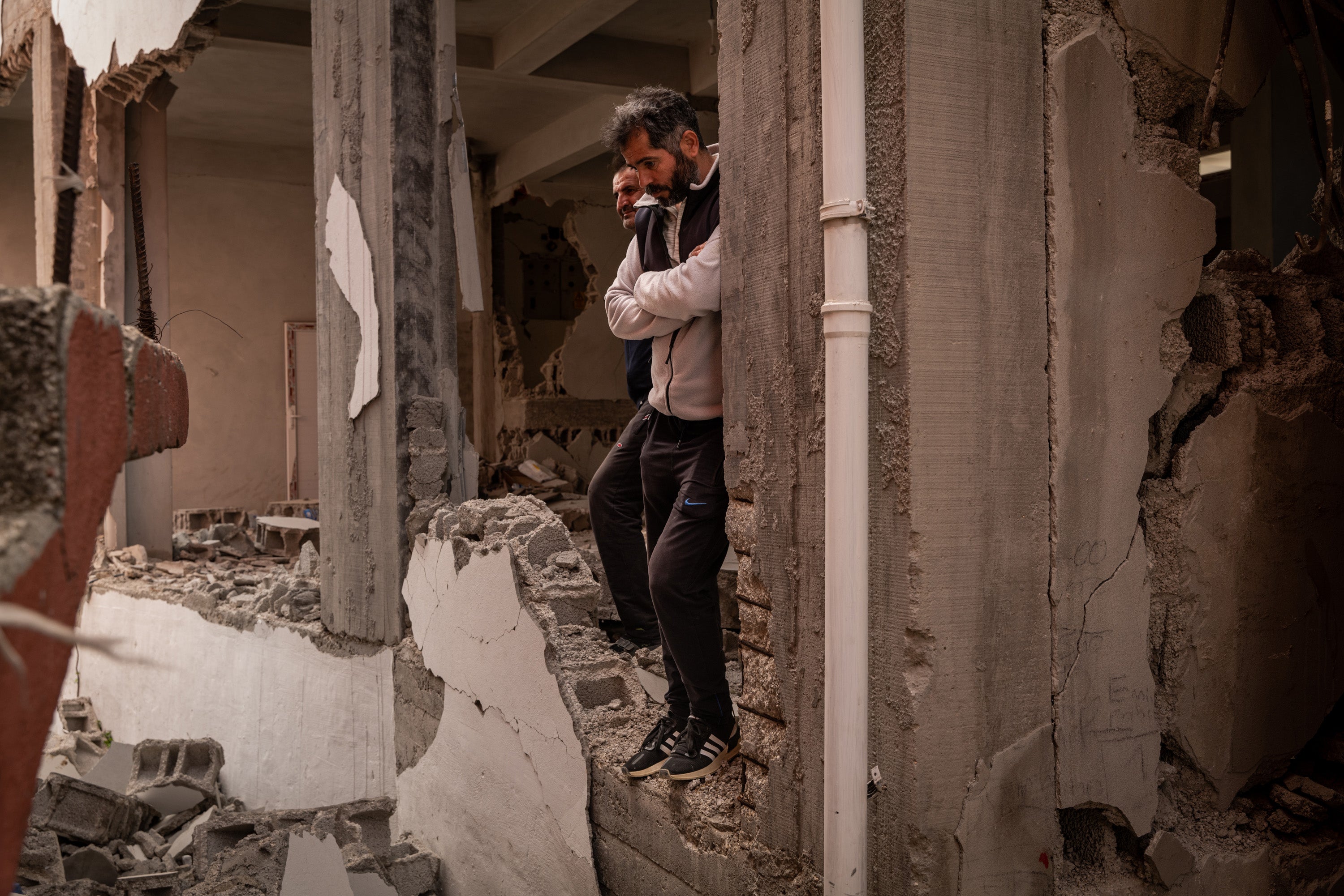 Residents survey the damage to their building