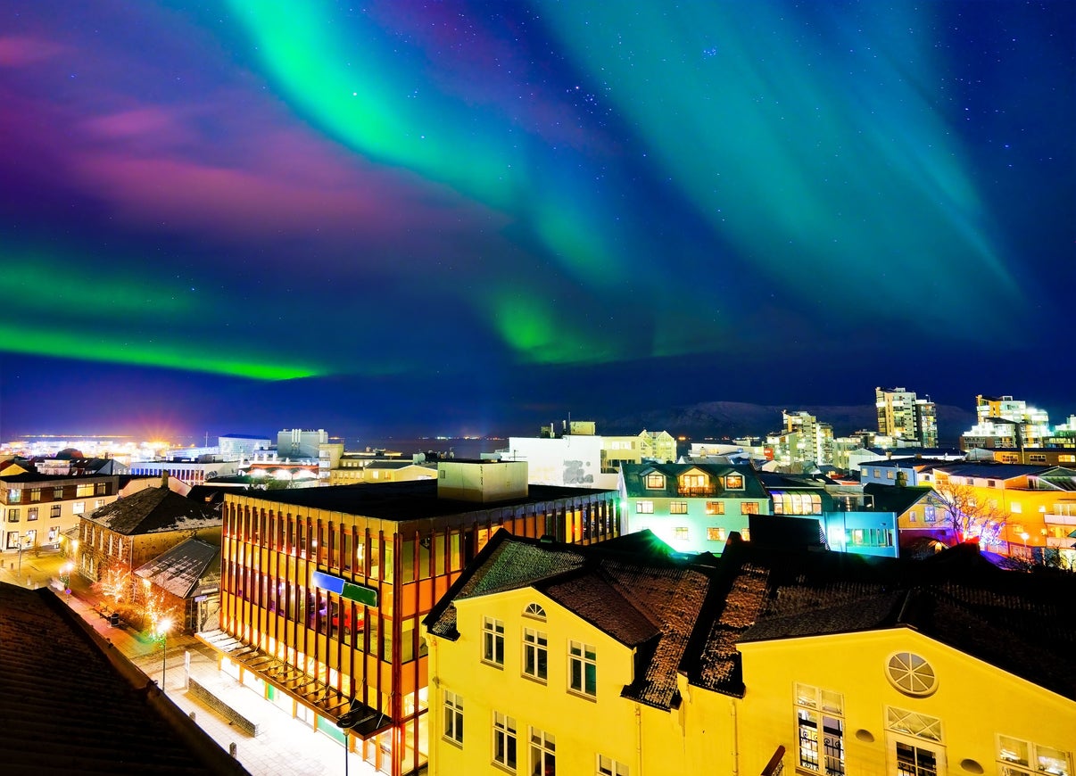 Whisps of purple and green illuminate central Reykjavik