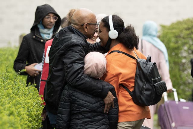 Hafiz Sinada greets his children as they arrive at the Radisson Blue hotel at Stansted Airport (Chris Radburn/PA)
