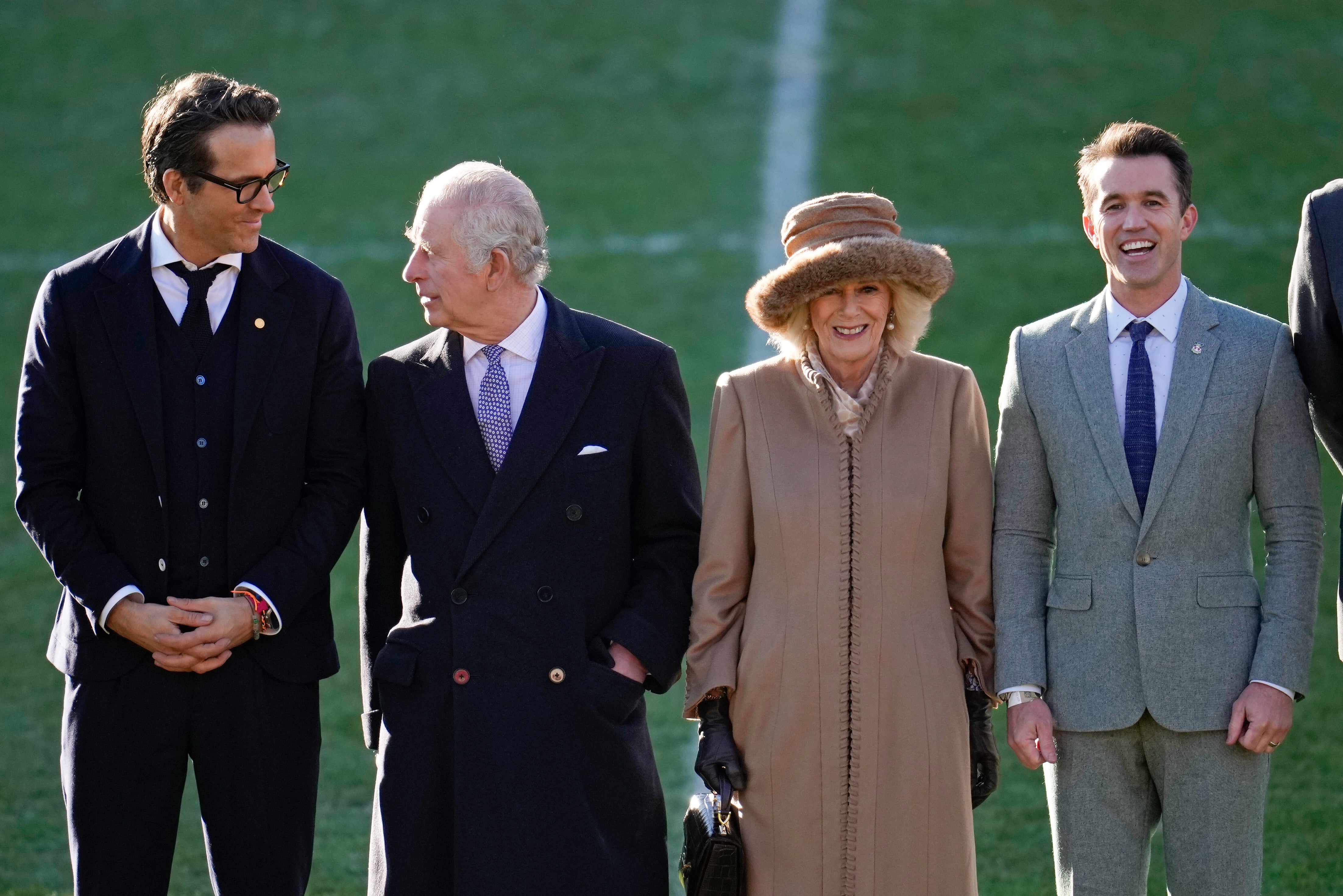 King Charles III and Camilla, Queen Consort talk to Wrexham AFC co-owners Ryan Reynolds and Rob McElhenney during their visit to Wrexham AFC on 9 December 2022