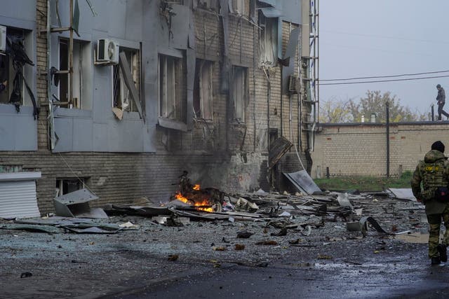 <p>File: A Russian serviceman walks at the site of a car explosion near the ‘ZaTV’ broadcaster building in Melitopol</p>