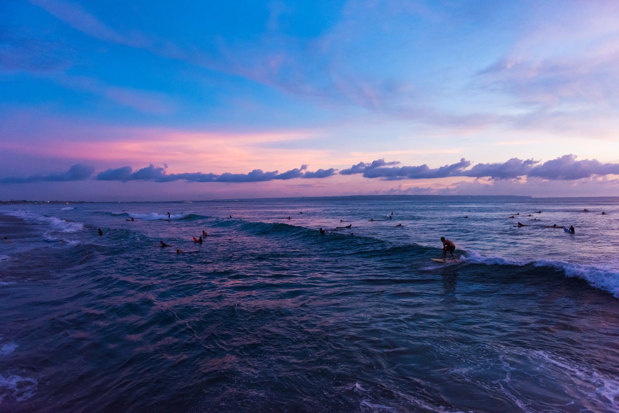 Surfers at sunset on Batu Bolong Beach in Canggu