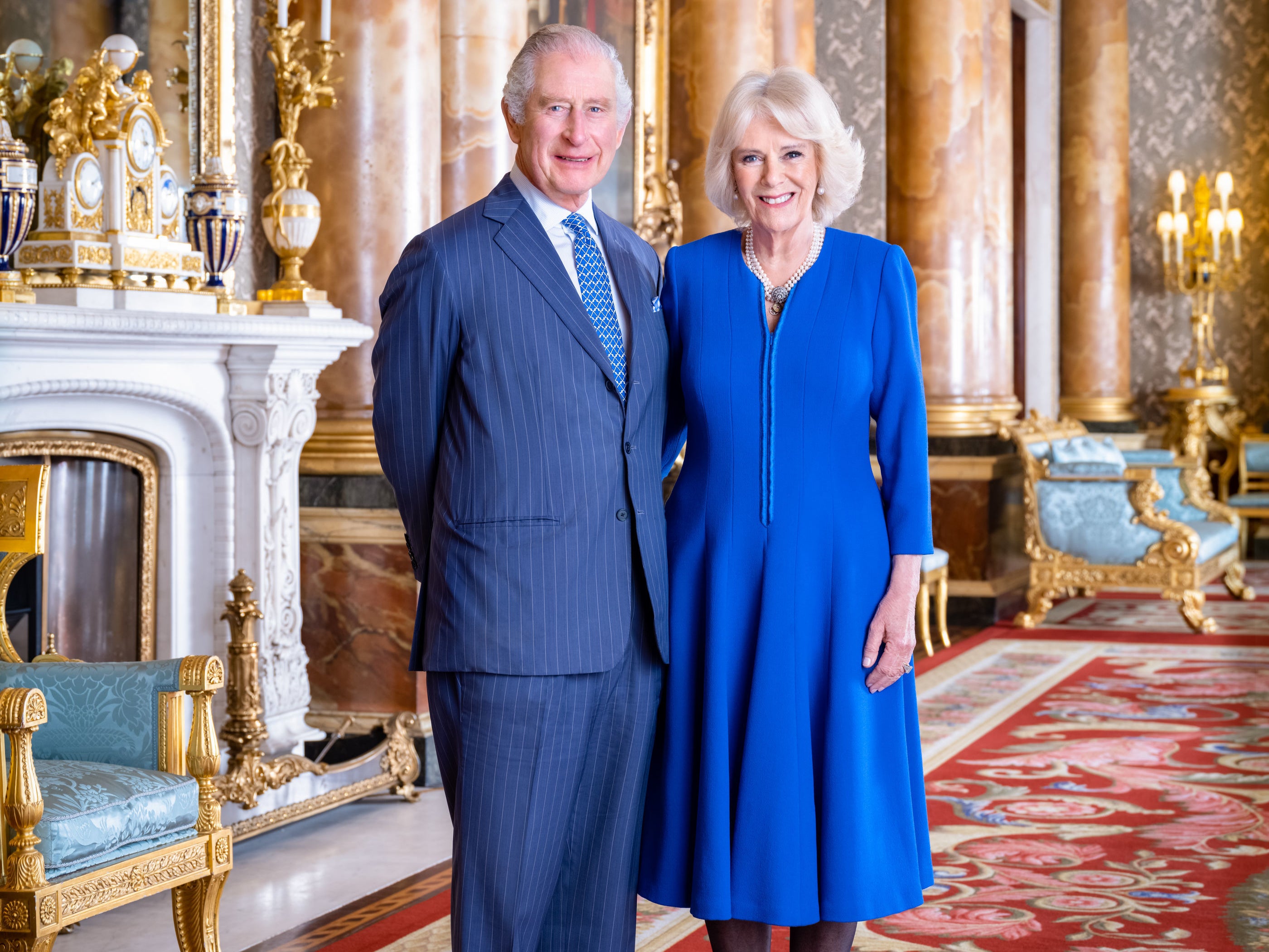 Handout photo issued by Buckingham Palace of King Charles III and the Queen Consort taken by Hugo Burnand in the Blue Drawing Room at Buckingham Palace, London