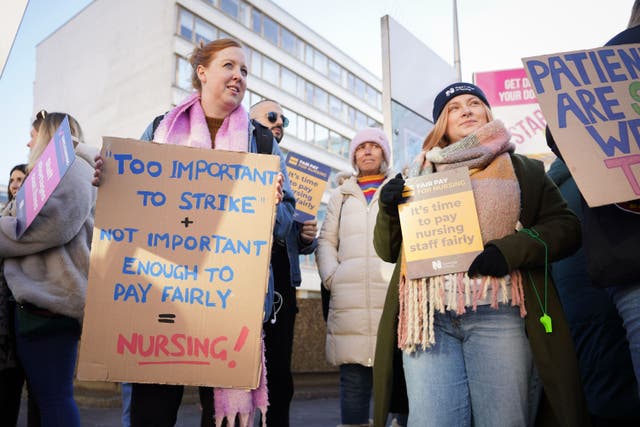 NHS staff stand on the picket line outside St Thomas’ Hospital in London (PA)
