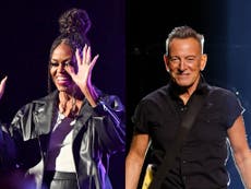 Moment Michelle Obama joins Bruce Springsteen to sing and play tambourine on stage