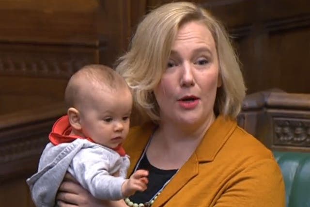 <p>Labour MP Stella Creasy holds her daughter in the House of Commons</p>