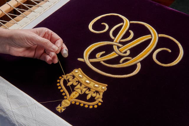 Work in progress of Queen’s Cypher on the Queen Consort’s Robe of Estate (PA)