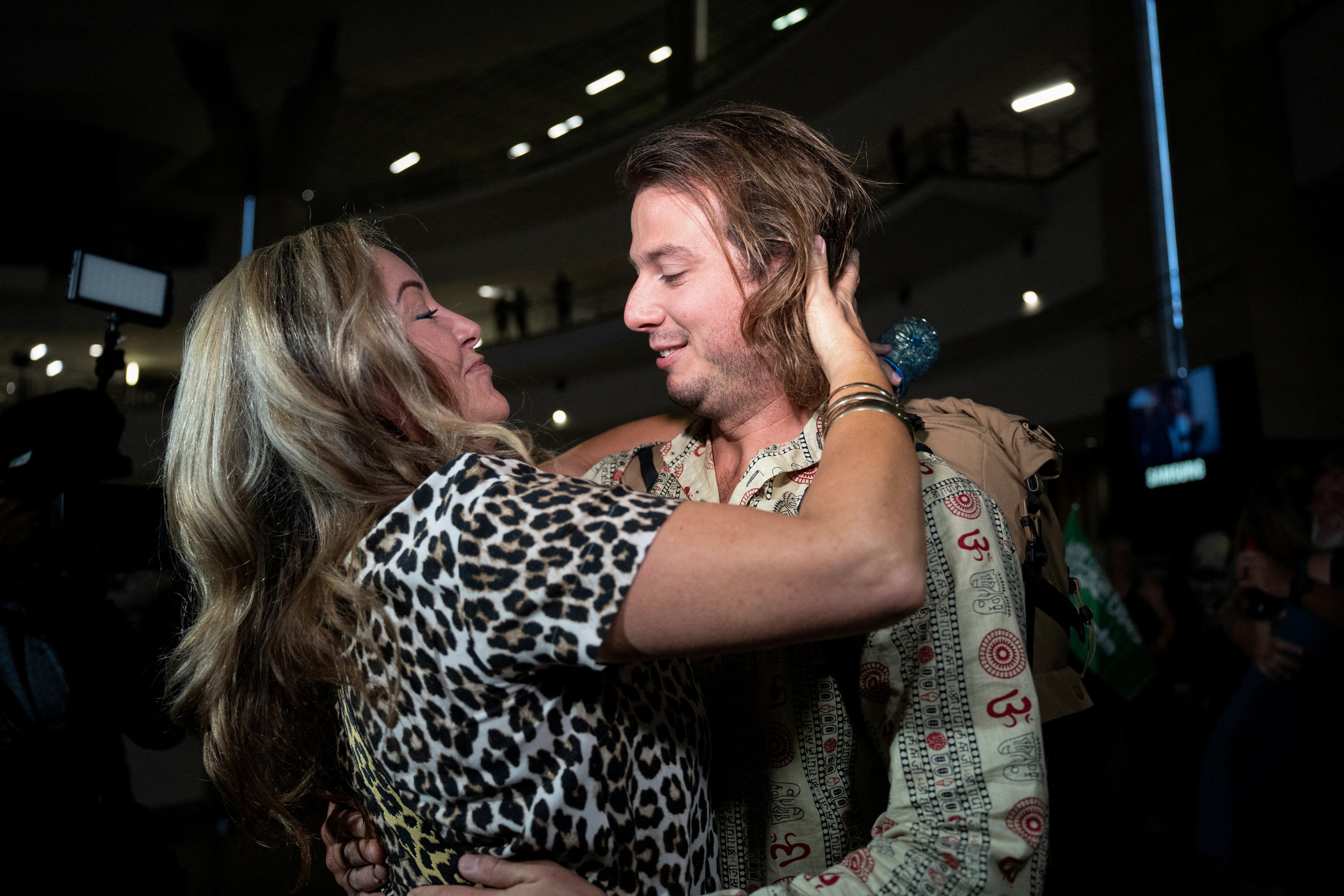 A family member greets Jonathan Hainsworth on his arrival at O.R. Tambo International Airport after he was evacuated from Sudan to escape the conflict