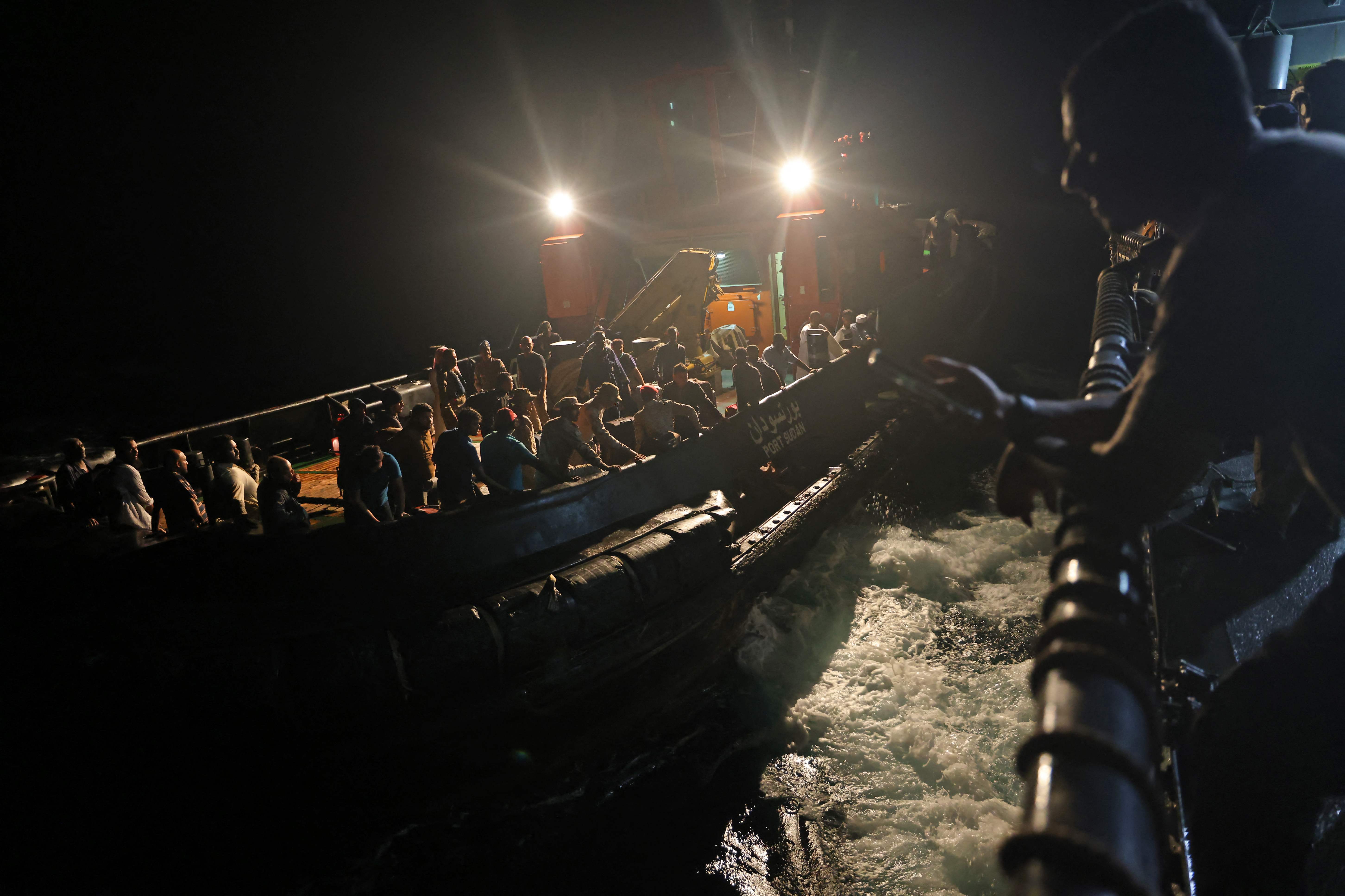 Evacuees are transported aboard a tugboat before boarding a Saudi vessel on April 30, 2023 during a rescue operation from Port Sudan to Jeddah