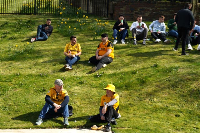 <p>Fans enjoy the warm weather outside the ground before the Premier League match at Molineux Stadium, Wolverhampton</p>
