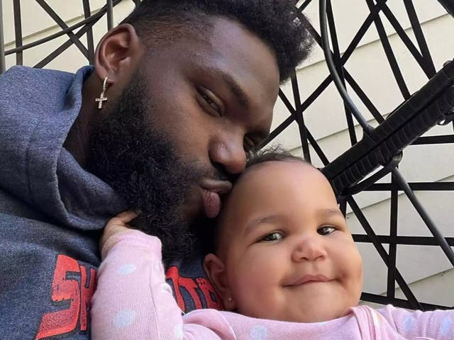 <p>Shaquil Barrett and his daughter</p>