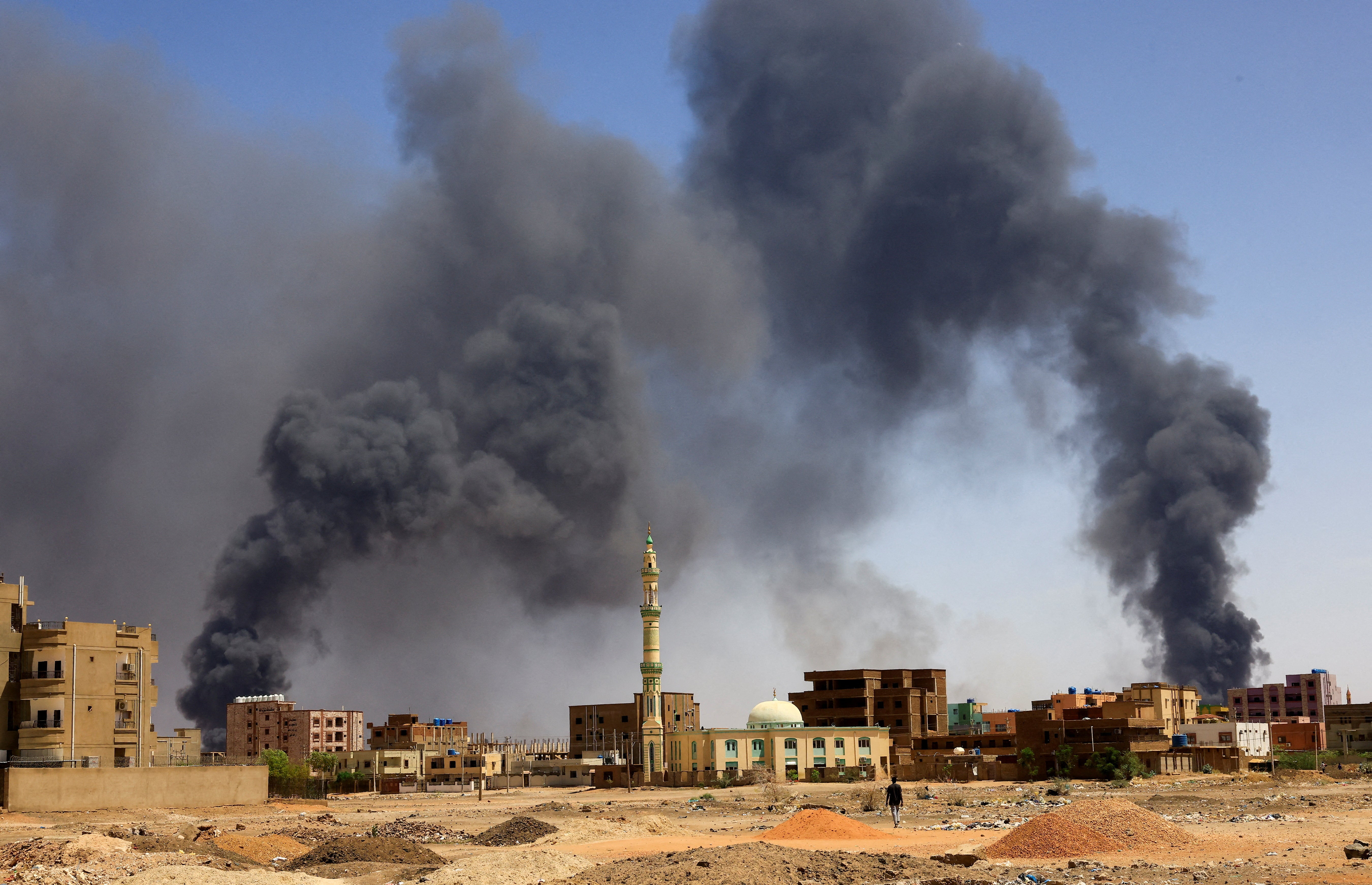 Smoke rises above buildings after aerial bombardment during clashes