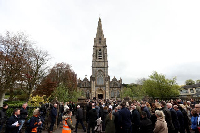 People attend a funeral for Dan and Christine McKane (Liam McBurney/PA)