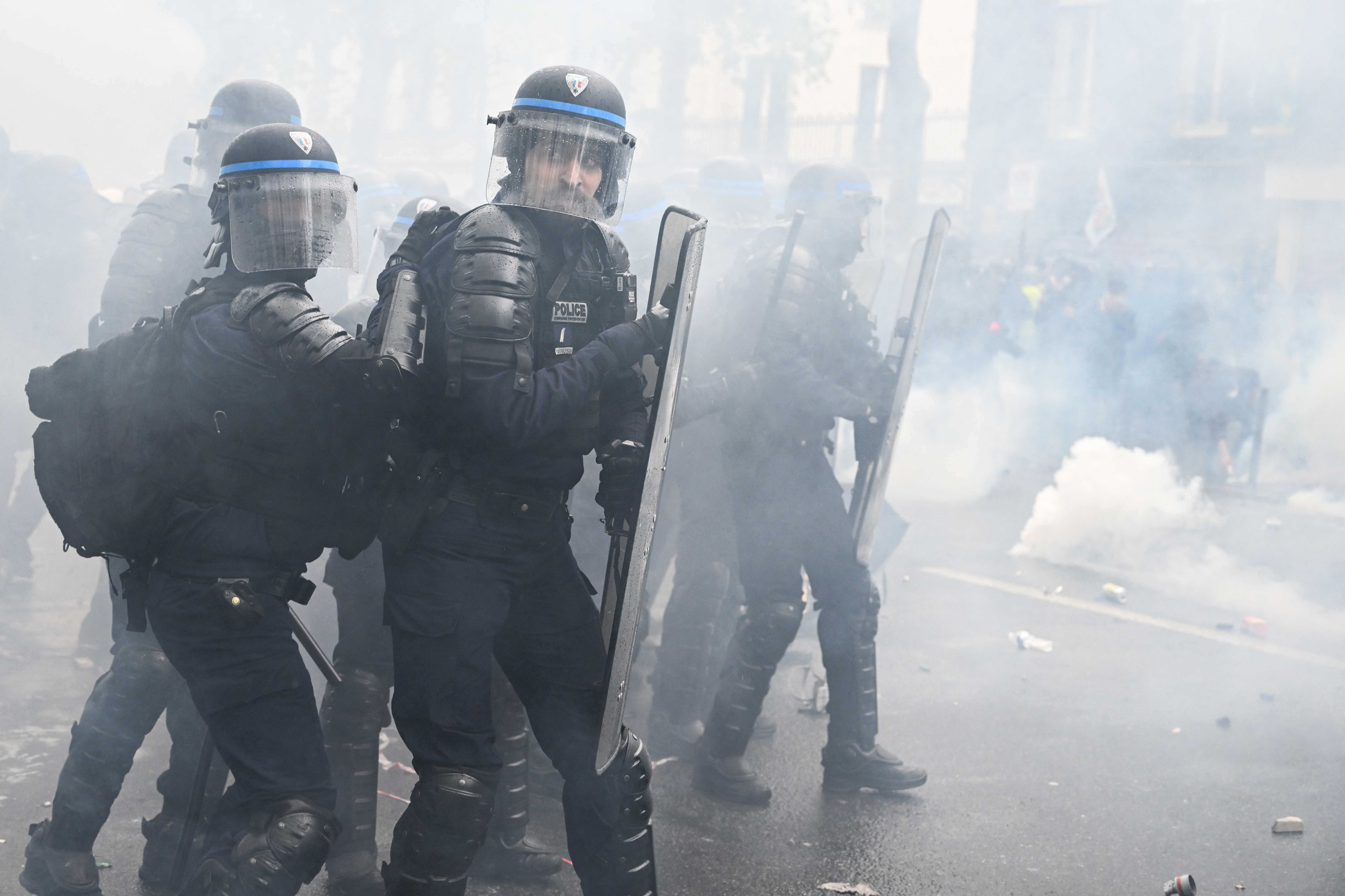 Police during clashes in Paris after tear gas was fired