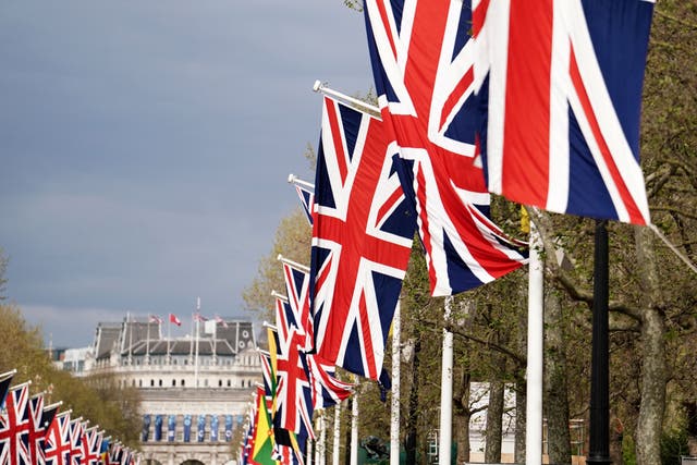 Union flags hang from the street furniture outside Buckingham Palace on the Mall, London, ahead of the coronation of King Charles III on Saturday May 6. Picture date: Monday May 1, 2023.