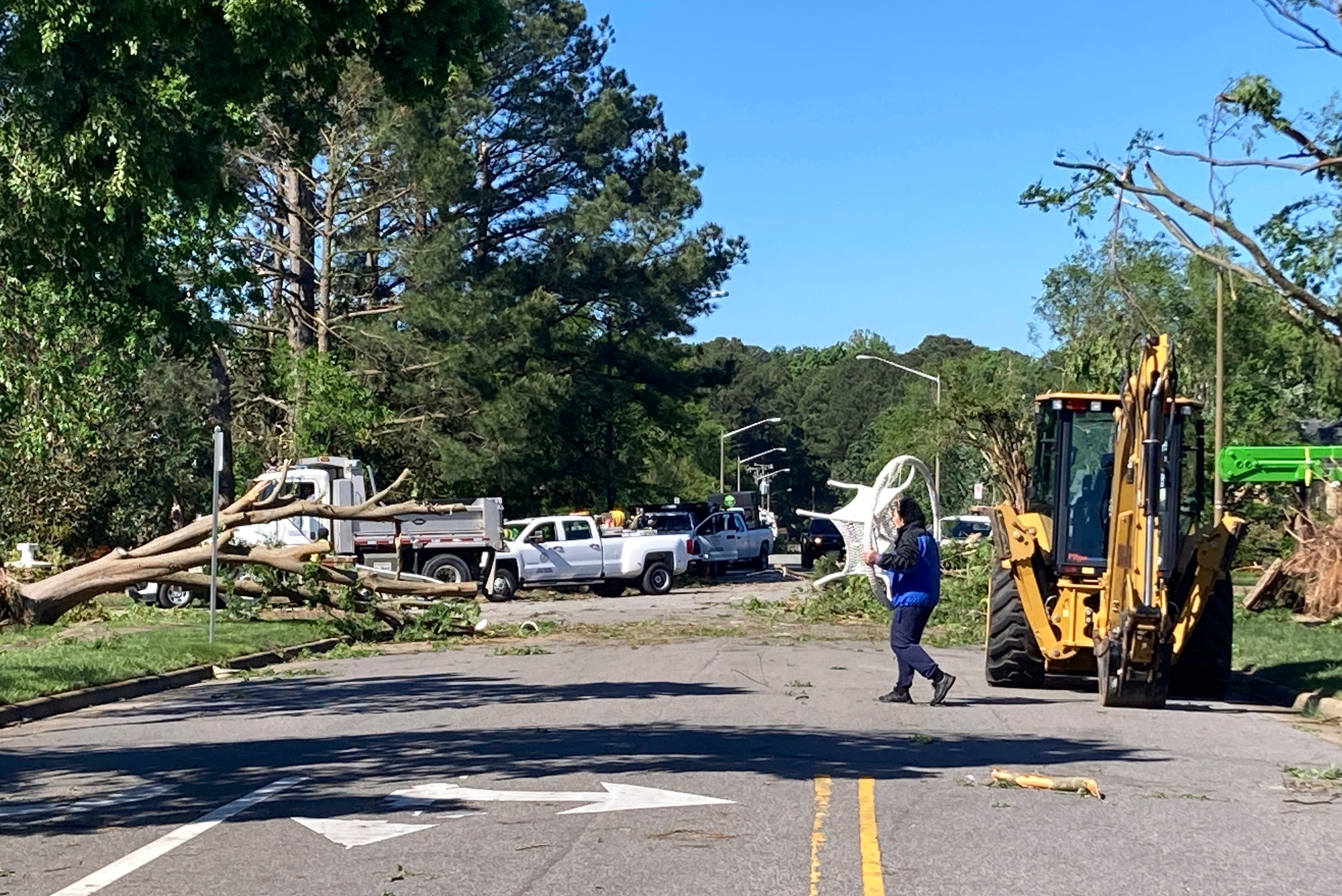 <p>A man carries a piece of furniture through a neighborhood in Virginia Beach, Va. on Monday May 1, 2023. The City of Virginia Beach declared a state of emergency after a tornado moved through the area and damaged dozens of home</p>