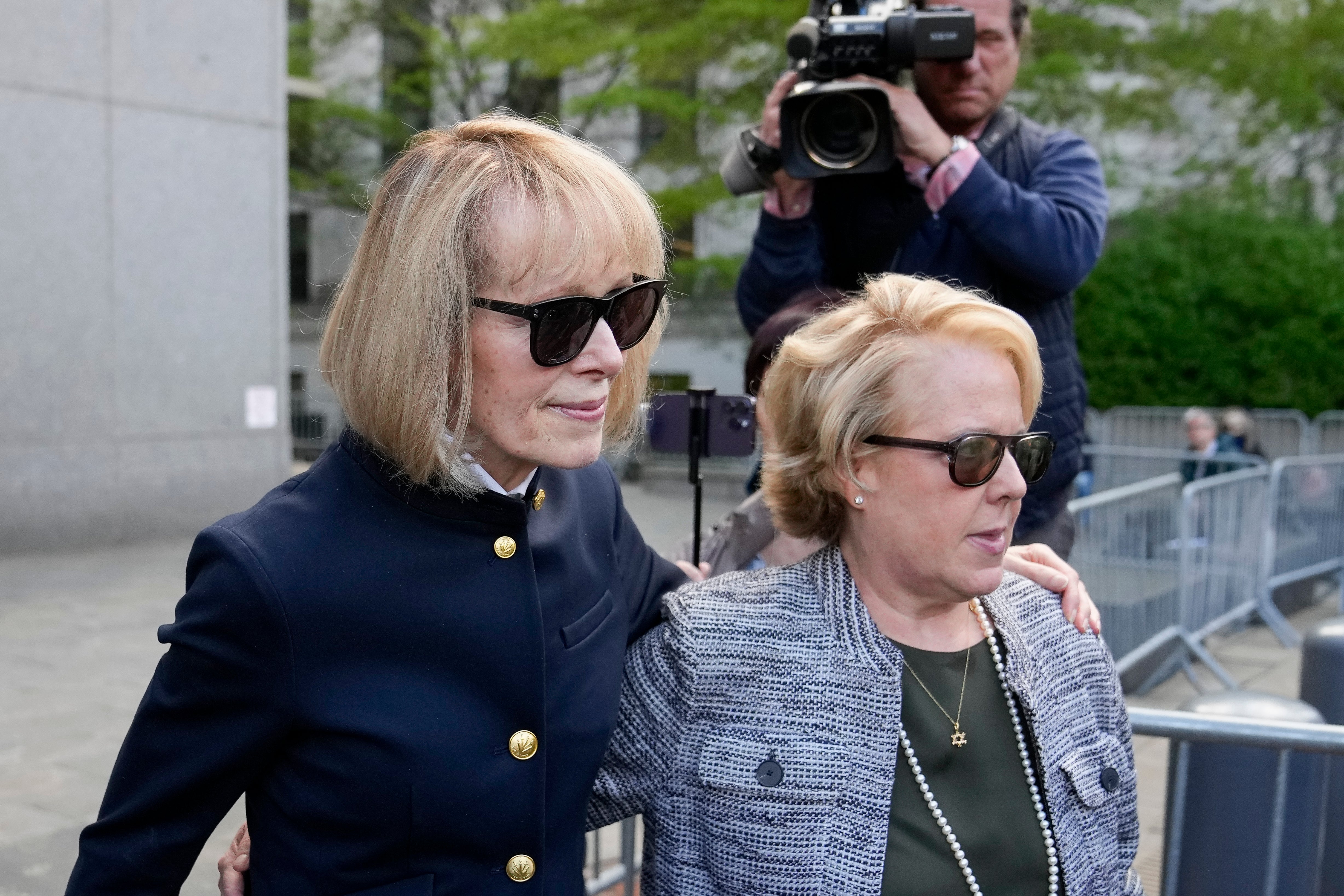 Former Elle advice columnist E Jean Carroll, left, departs Manhattan federal court, with her attorney Roberta Kaplan, on Monday, May 1.