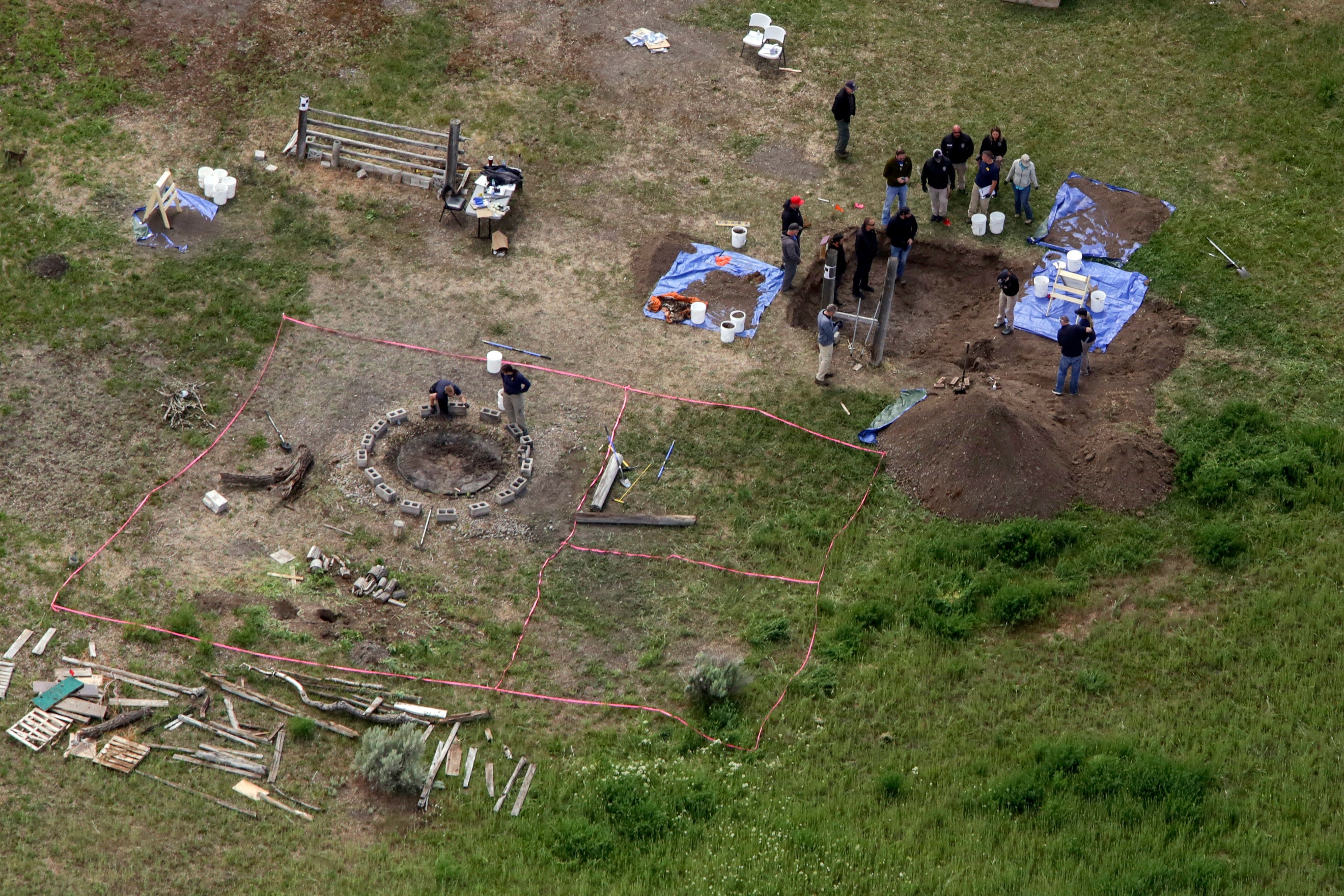 Investigators are seen digging up the bodies of JJ and Tylee in June 2020