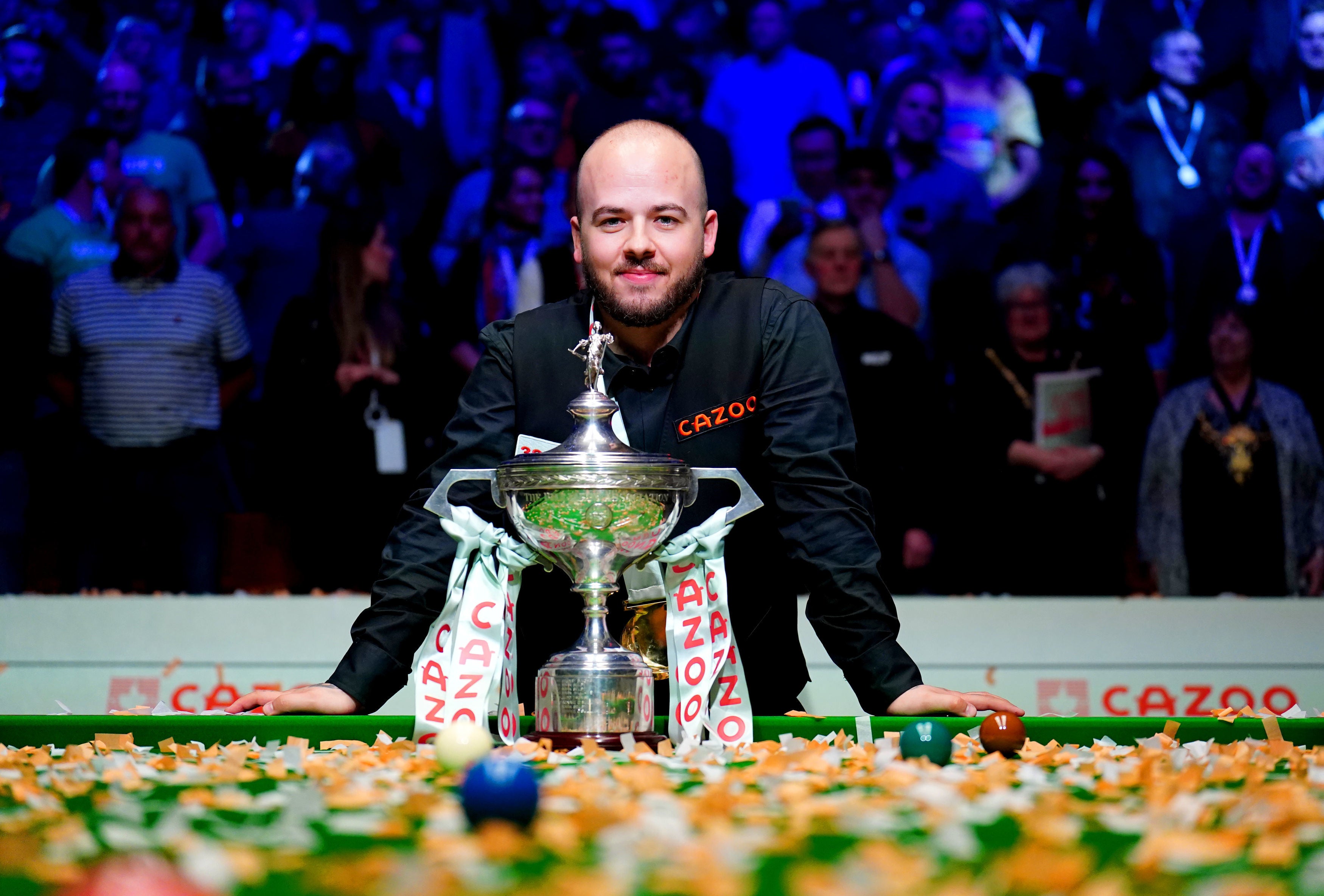 Luca Brecel poses with the World Snooker Championship trophy